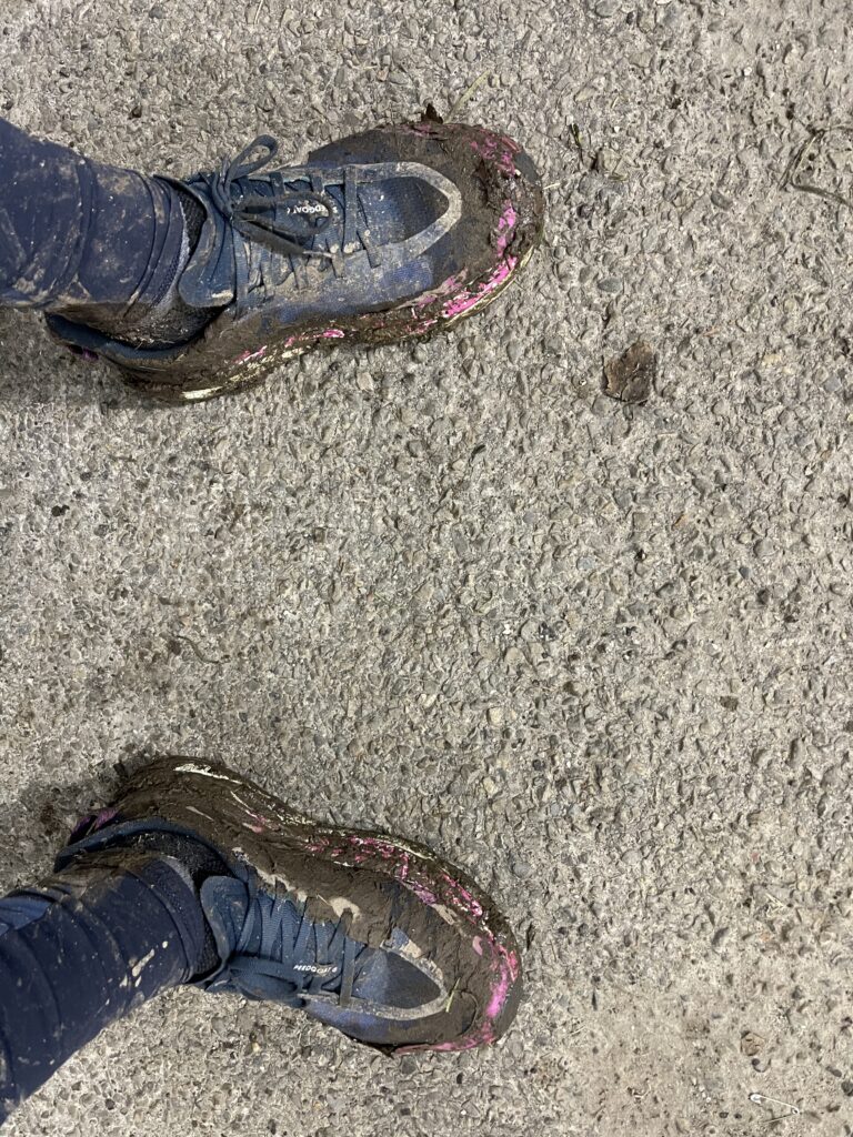 Muddy trail running shoes after a 26K trail run, symbolizing mental toughness and resilience in running